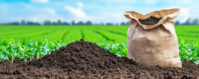 Fresh bag of nutrient-rich soil displayed on a farm background, ready for planting, gardening, and agricultural use.