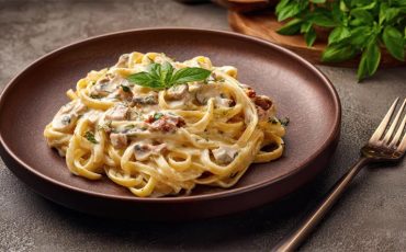 30-Minute Creamy Garlic Wild Mushroom Fettuccine garnished with basil