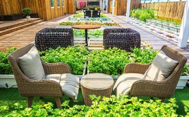 Covered lifestyle garden featuring a seamless indoor-outdoor living space with comfortable seating, lush greenery, and stylish landscaping.